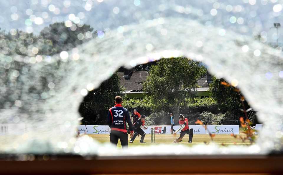 A view of the match through a broken window