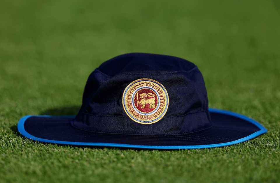 A Sri Lanka hat lies on the ground with the SLC logo prominent on it