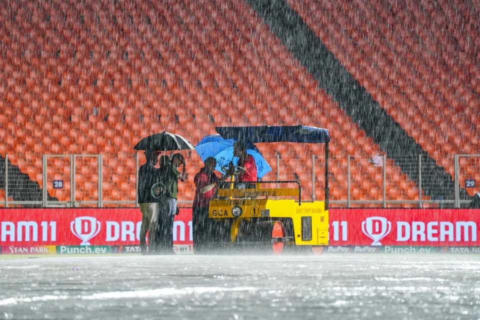Rain bashes down at the Narendra Modi Stadium as the ground staff are kept busy, Gujarat Titans vs Kolkata Knight Riders, IPL 2024, Ahmedabad, May 13, 2024
