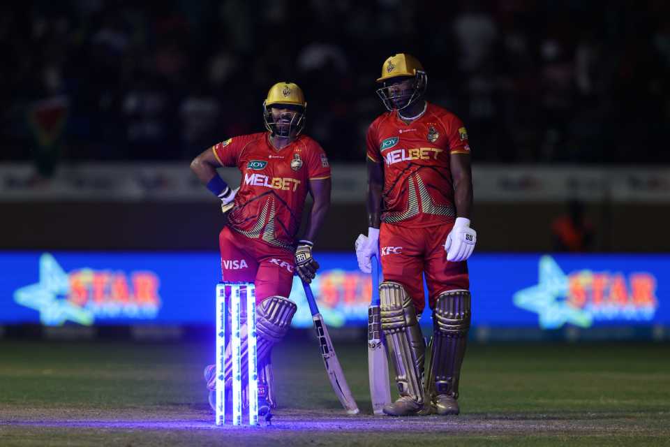 Nicholas Pooran and Andre Russell wait as a floodlight failure brings a pause in play, Trinbago Knight Riders vs Barbados Royals, Eliminator, CPL 2024, October 1, 2024
