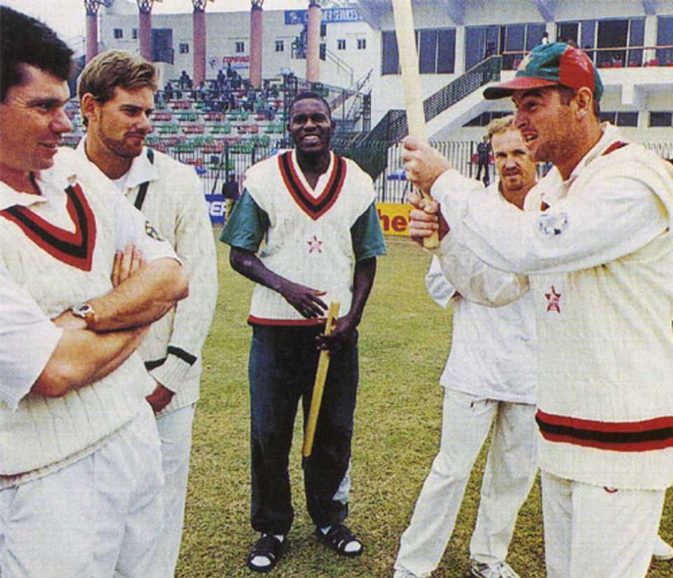 Alastair Campbell celebrates Zimbabwe's first Test series win overseas after the third Test against Pakistan was drawn.  Adam Huckle, Neil Johnson, Pommie Mbangwa and Grant Flower look on, Pakistan v Zimbabwe, 3rd Test, December 21, 1998