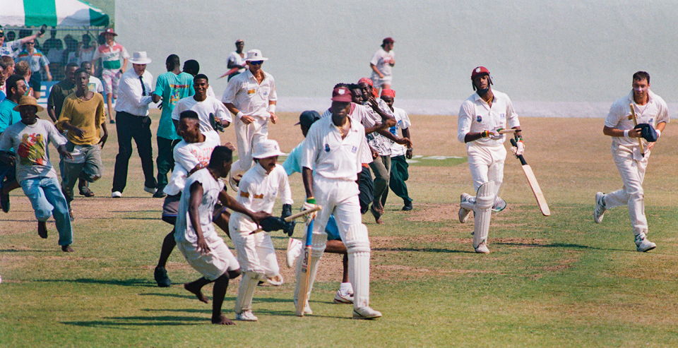 England and West Indies players make their way back to the pavilion as spectators invade the ground, West Indies v England, 4th Test, 2nd day, Bridgetown, April 13, 1994