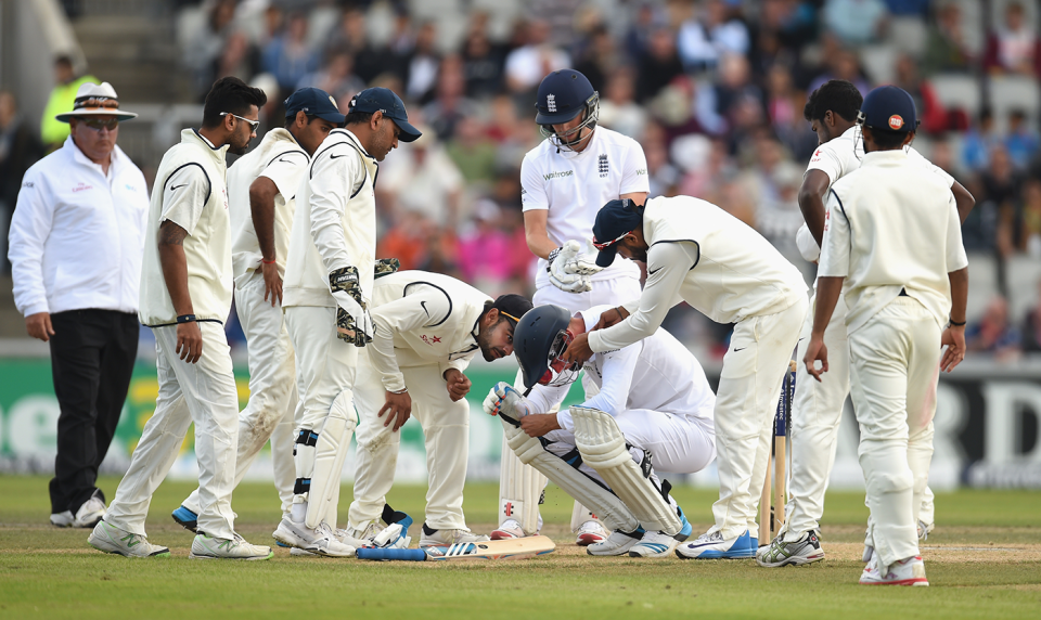The Indian players check on Stuart Broad, who was struck on the nose by a Varun Aaron bouncer, England v India, 4th Test, Old Trafford, 3rd day, August 9, 2014