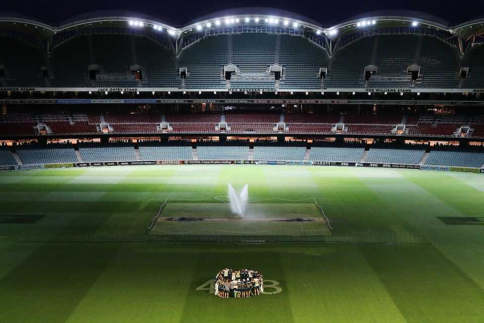 The Australian players huddle over Phil Hughes' 408 after their win, Australia v India, 1st Test, Adelaide, 5th day, December 13, 2014
