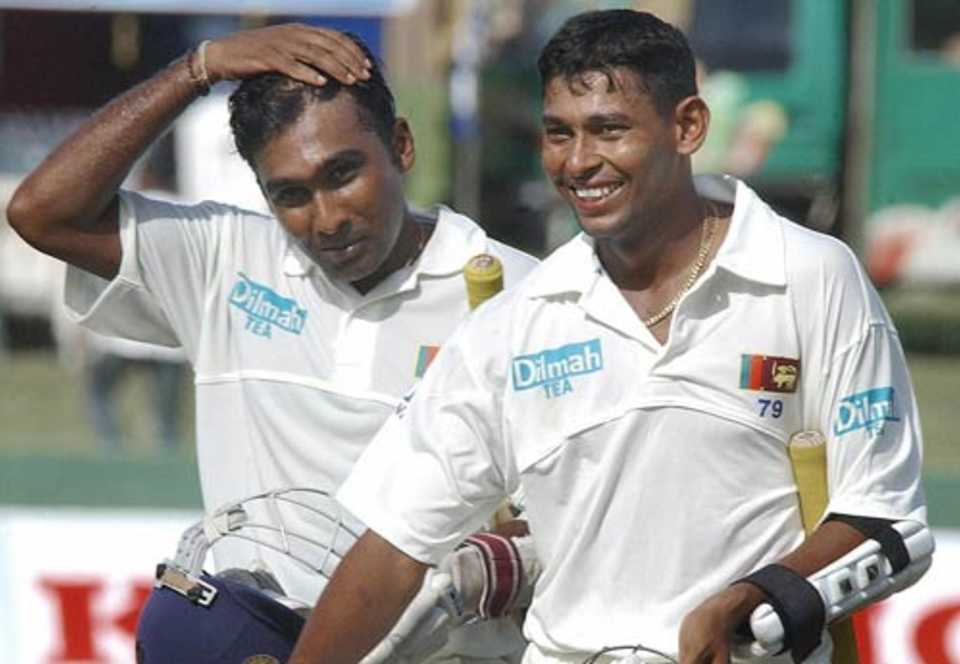 Mahela Jayawardene and Tillakaratne Dilshan return to the pavilion after Sri Lanka's six-wicket win in the first Test against West Indies, July 16, 2005