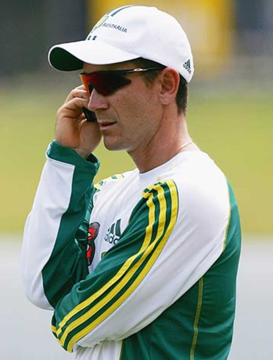 Justin Langer, nursing a cracked rib, talks on the phone during training, Allan Border Field, Brisbane, October 31, 2005