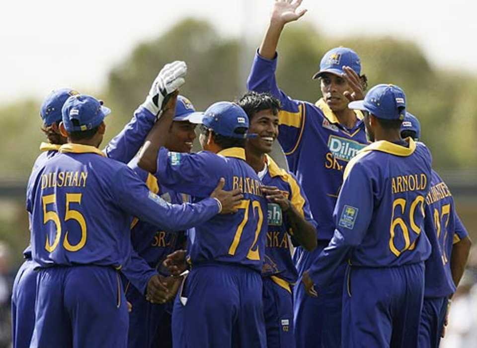 Sri Lankan players celebrate a wicket during the tour match against Victoria
