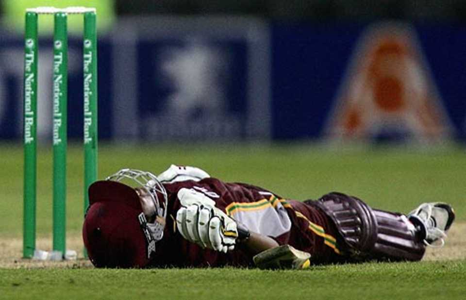 Ramnaresh Sarwan lies flat on the pitch after holding out to long-on
