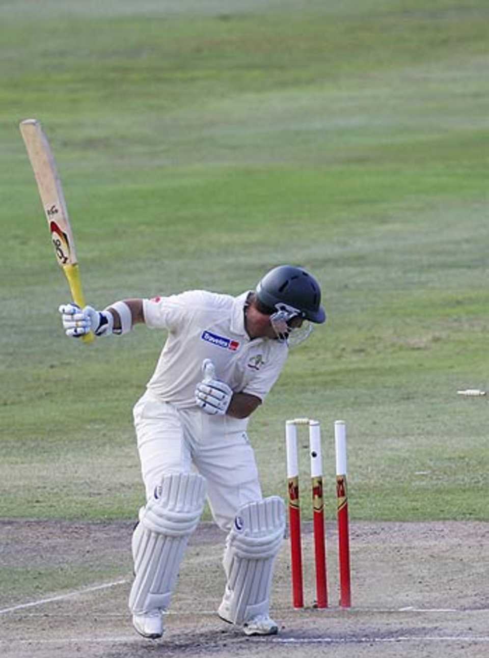 Justin Langer chops the ball back onto his stumps