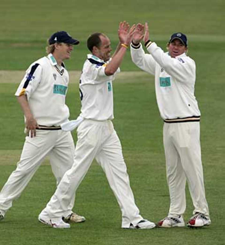 Billy Taylor is congratulated by his captain, Shane Warne