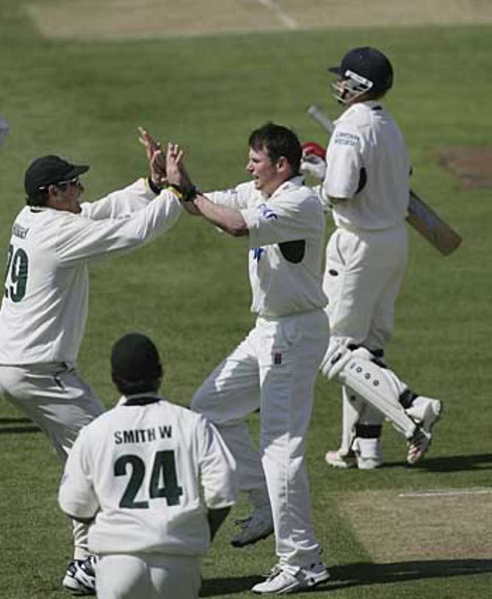 Andrew Harris is congratulated on the key wicket of Ian Bell