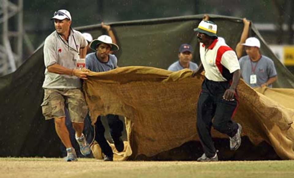 Groundstaff in Kuala Lumpur drag the sheets on, India v Australia, 3rd match, DLF Cup, Kuala Lumpur, September 16, 2006