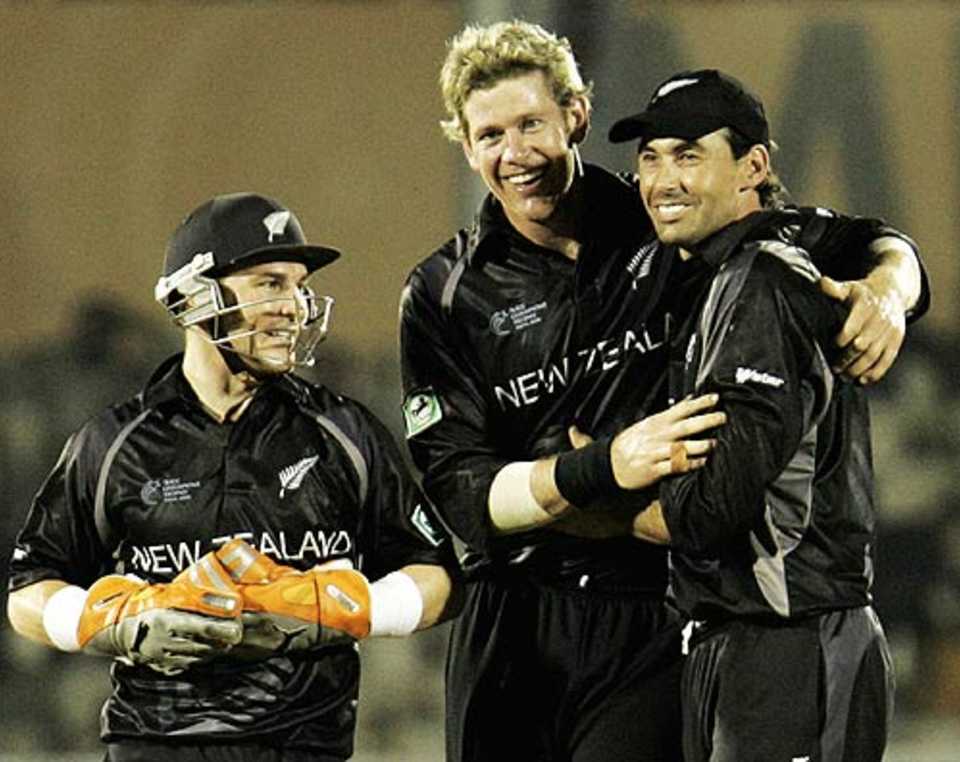Jacob Oram pleases his captain, Stephen Fleming, with another scalp as Brendon McCullum looks on