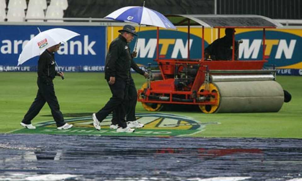 The umpires return after checking out the conditions