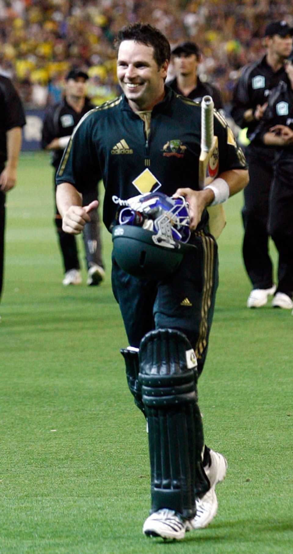 A delighted Brad Hodge leads Australia off