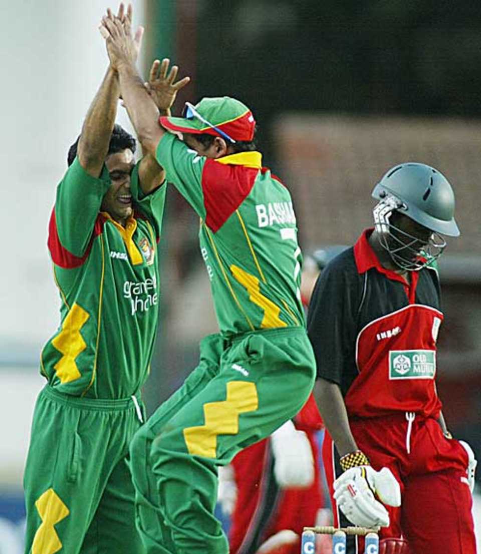 Bangladesh players celebrate the wicket of Elton Chigumbura