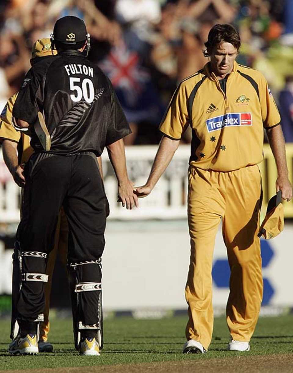 A dejected Glenn McGrath shakes hands with Peter Fulton