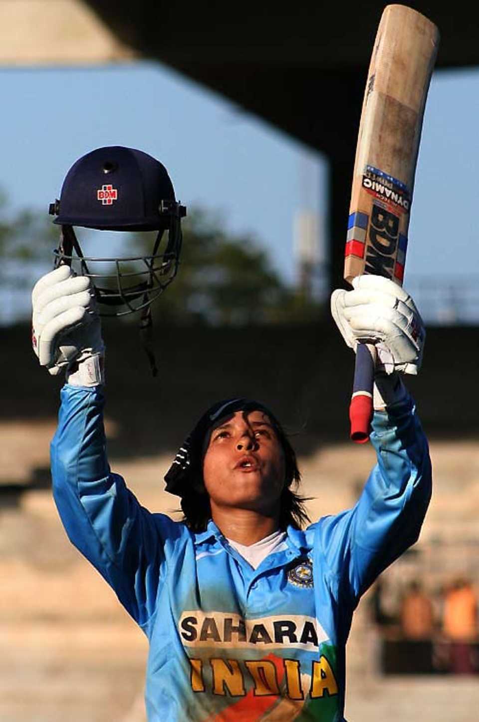 Jaya Sharma raises her bat after an unbeaten 104