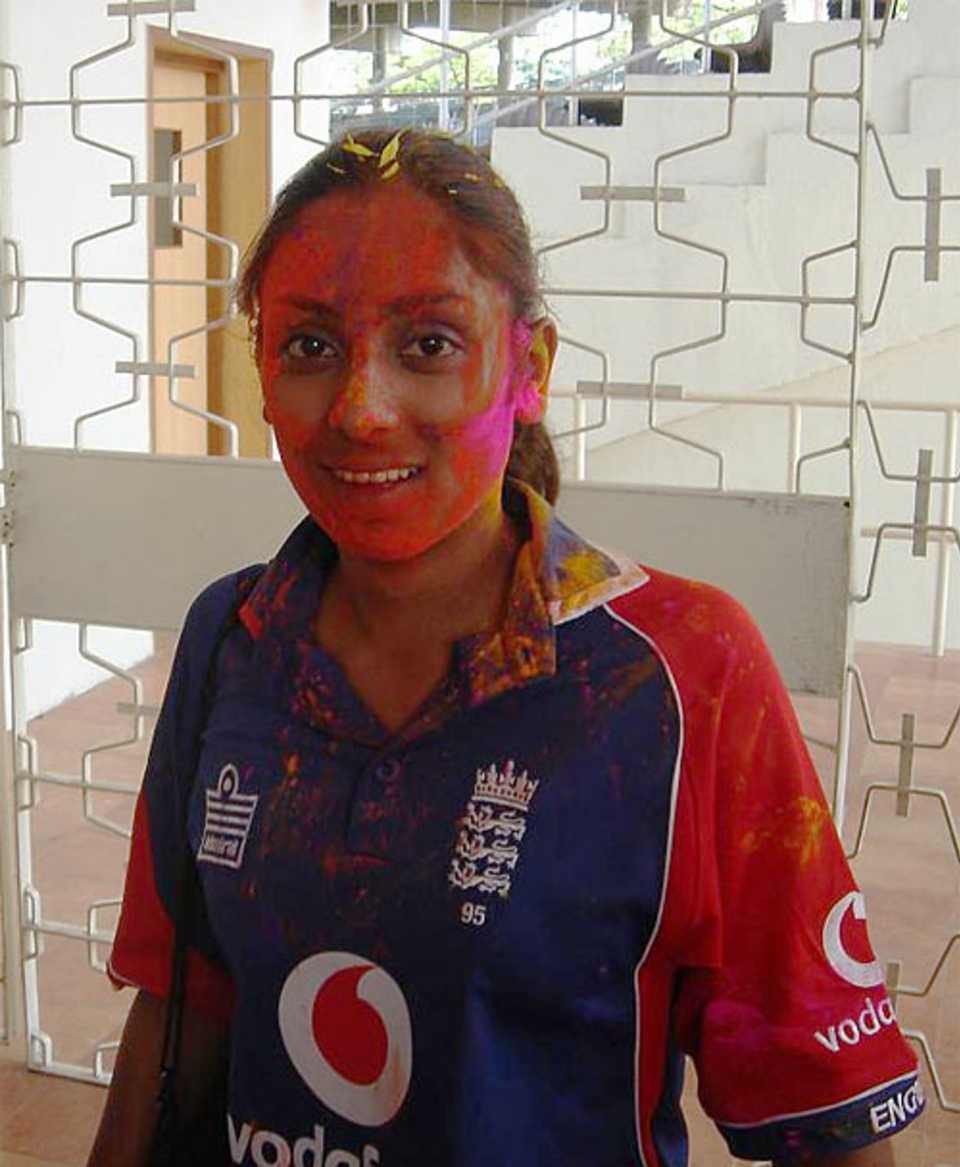 Isa Guha is covered in coloured powder at a Hindu festival
