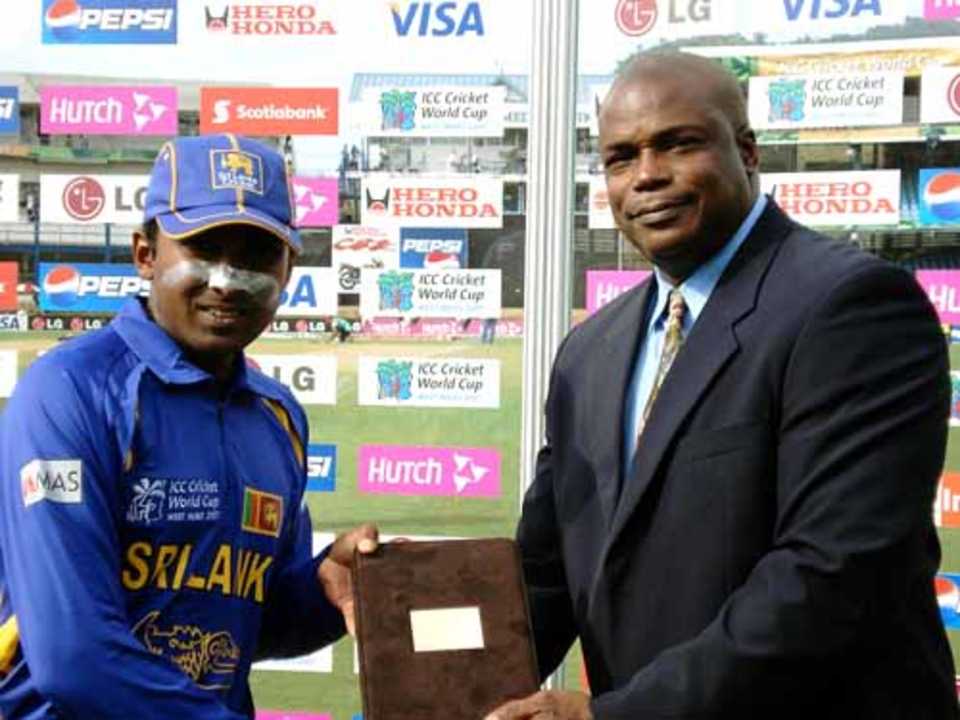 Hasely Crawford, a former Olympic gold medallist, presents the Man-of-the-Match award to Mahela Jayawaradene after Sri Lanka's 243-run win over Bermuda