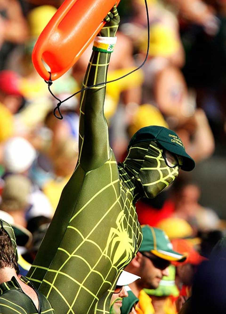 A fan dressed in a green and gold Spiderman outfit cheers for Australia