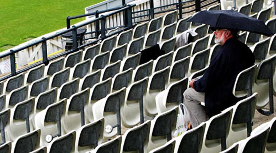 Typically English: a supporter at Lord's watches the rain fall, Middlesex v Essex, County Championship, Lord's, June 16, 2007