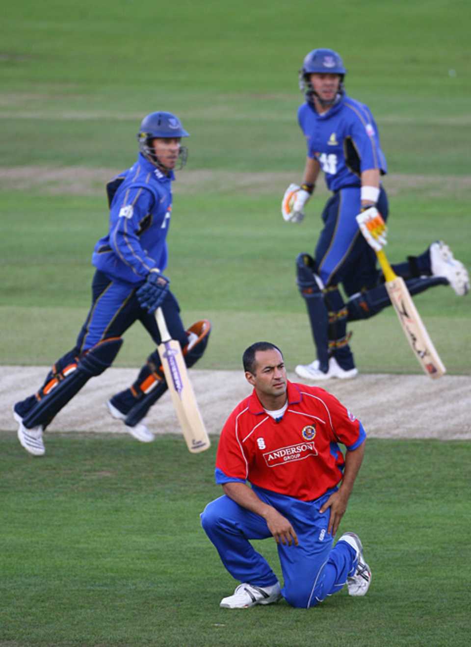 Adam Hollioake, kneeling, watches another Sussex boundary speed to the fence