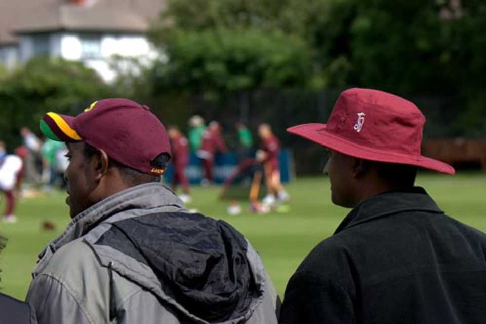 A couple of West Indies supporters watch their team practice