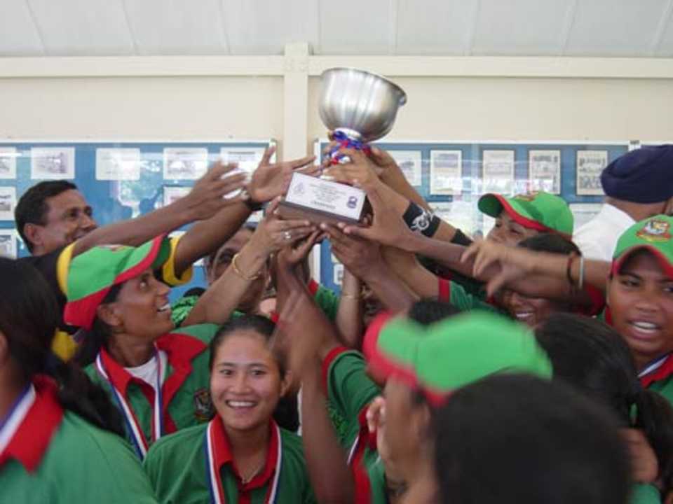 Champagne moment: Champa Chakma and her team-mates lift the cup