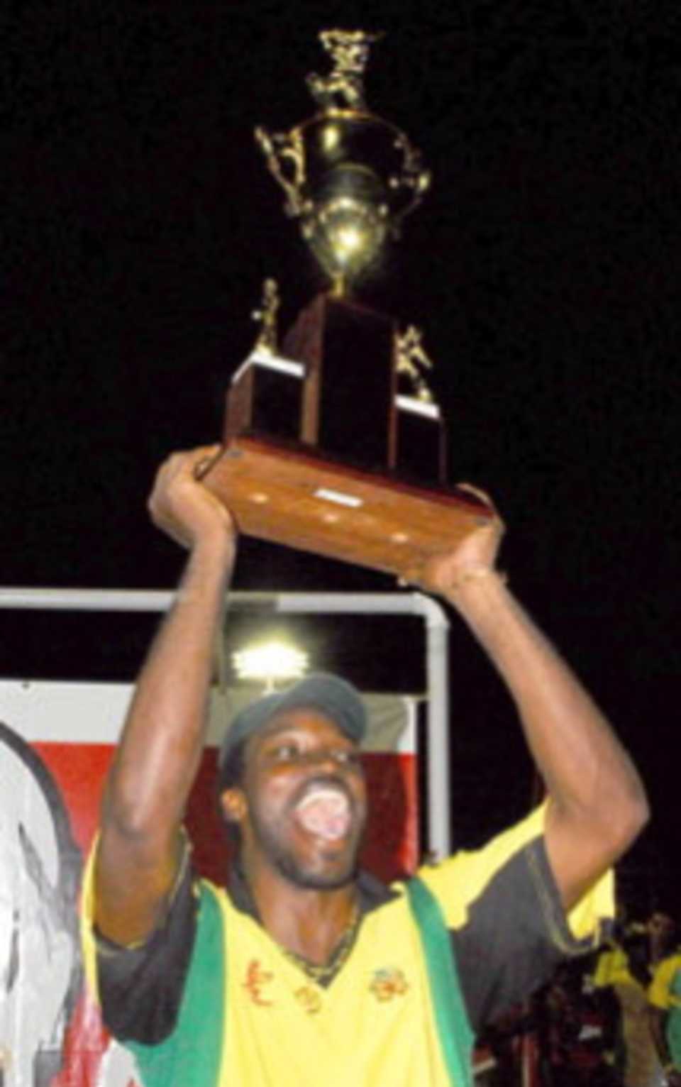 Chris Gayle lofts the KFC Cup trophy after Jamaica beat Trinidad & Tobago