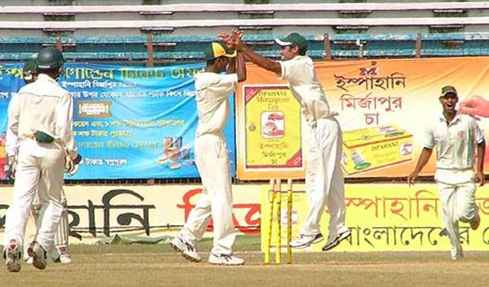 Rajshahi players rejoice at the fall of a wicket