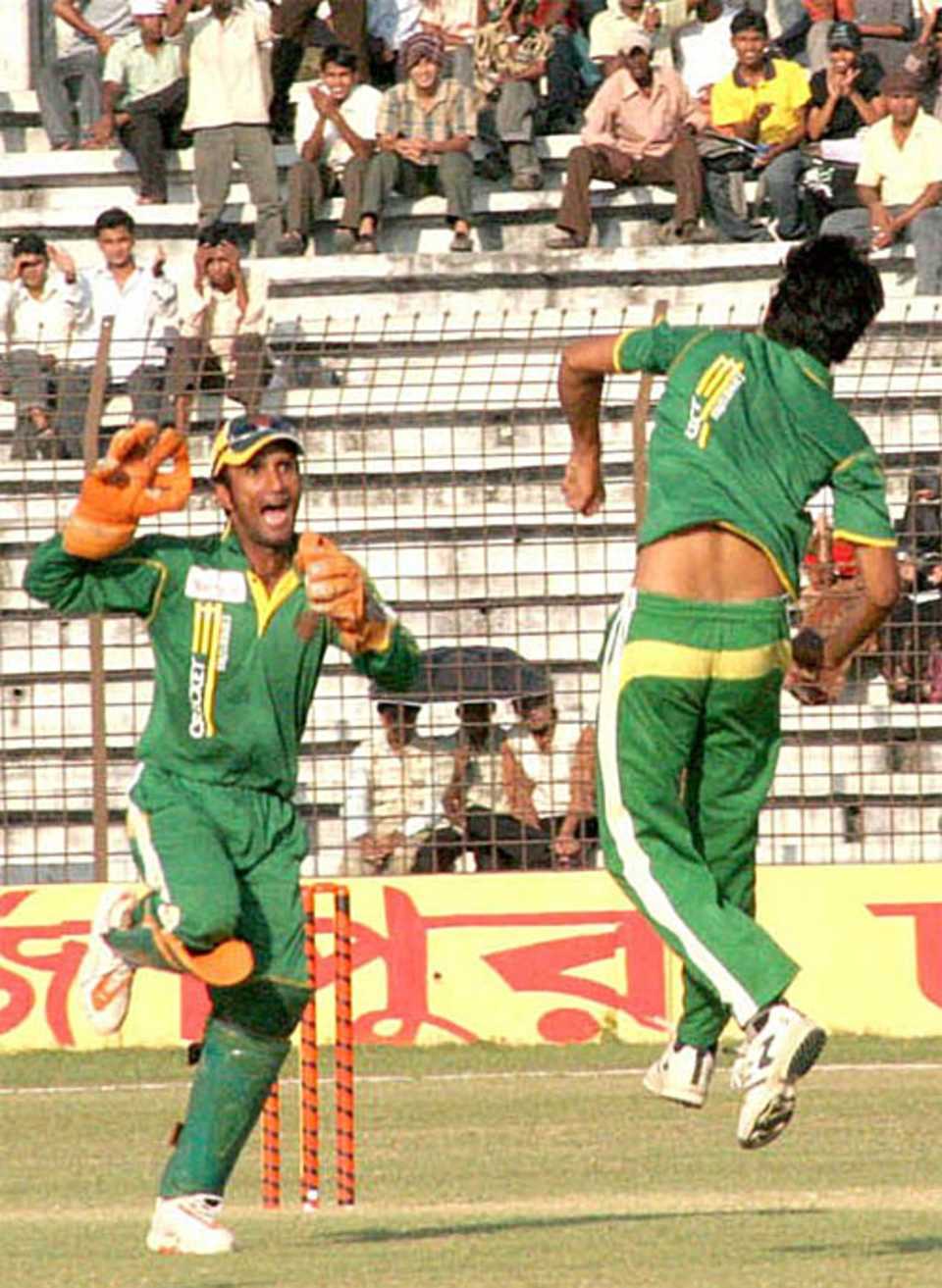 Khaled Mashud and Saqlain Sajib celebrate a wicket