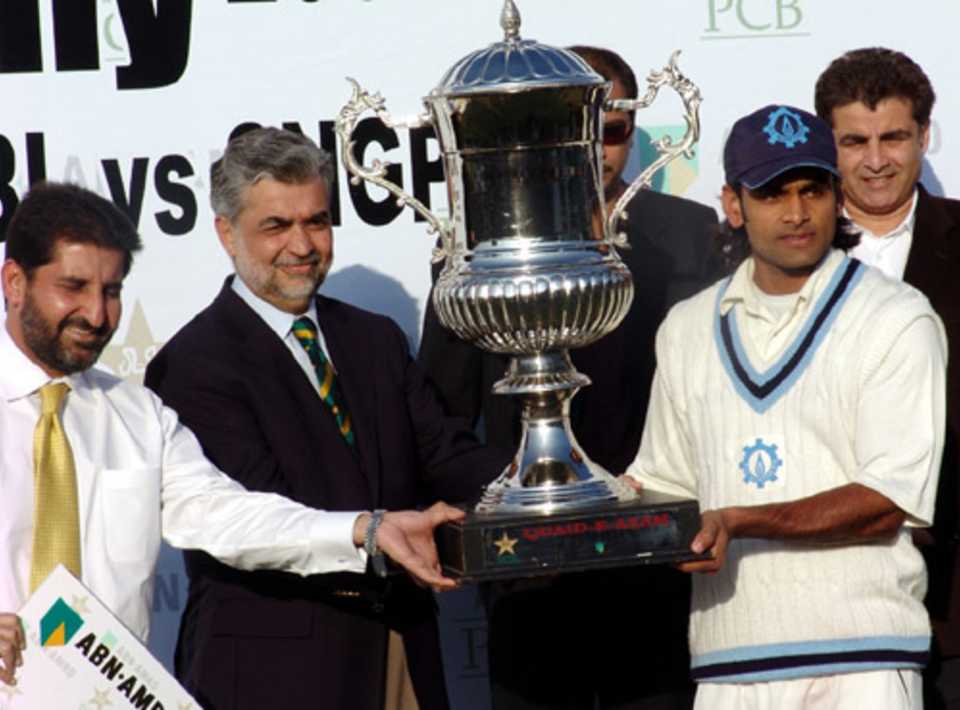 Mohammad Hafeez, the captain of  Sui Northern Gas Pipeline Limited, receives the silverware 