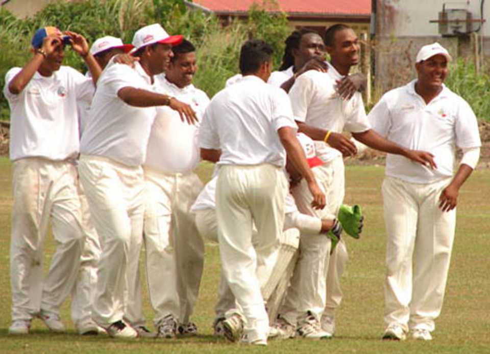 Suriname and Troy Dudnauth celebrate another Bahamas wicket