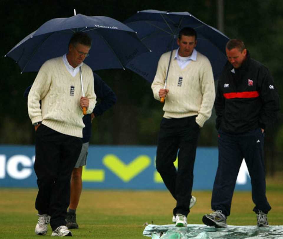 Umpires Steve Garratt and Michael Gough inspect the pitch