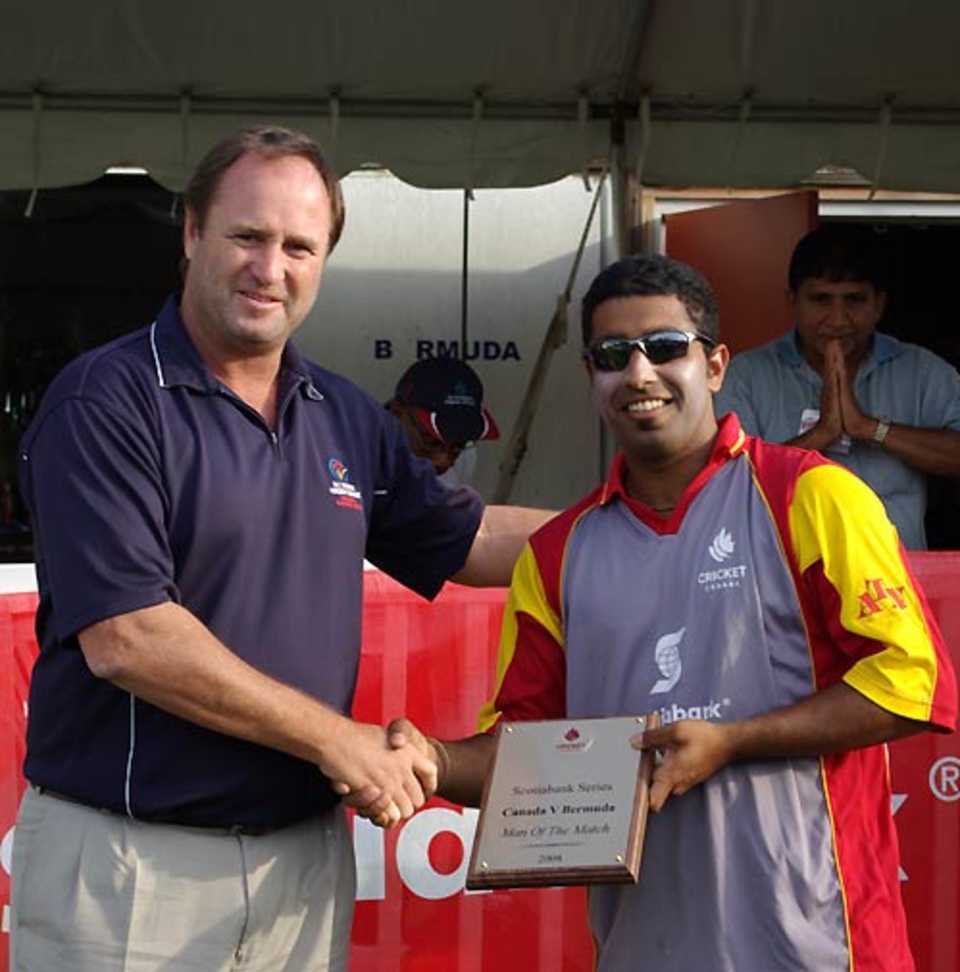 Karun Jethi receives the Man-of-the-Match award from Richard Done for his all-round show