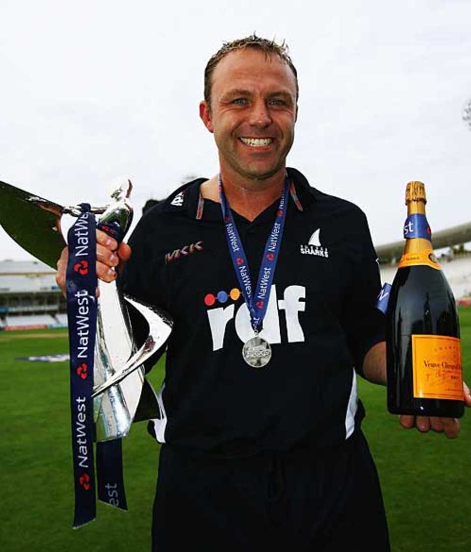 Not a bad day's work: Chris Adams with the Pro40 trophy and champagne