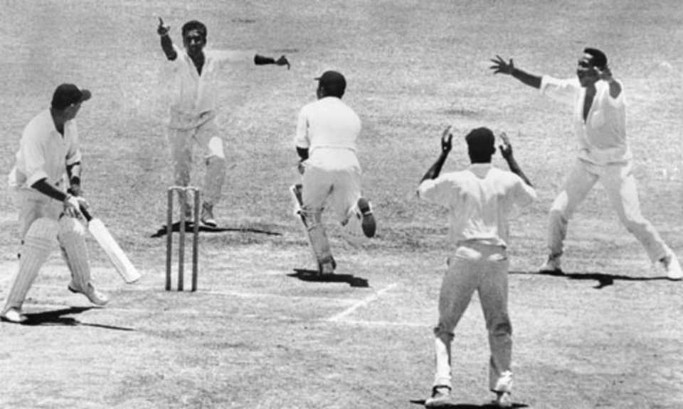 Tom Graveney is caught-behind by Deryck Murray after the ball ricochets off Garry Sobers' leg