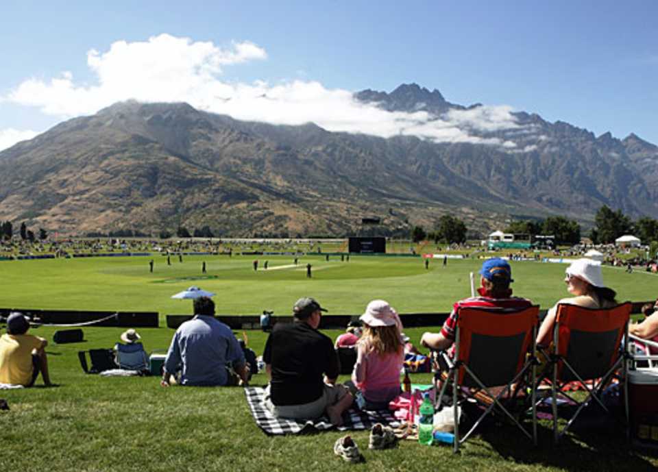 Spectators take in the view of the Remarkables mountain range while watching a game