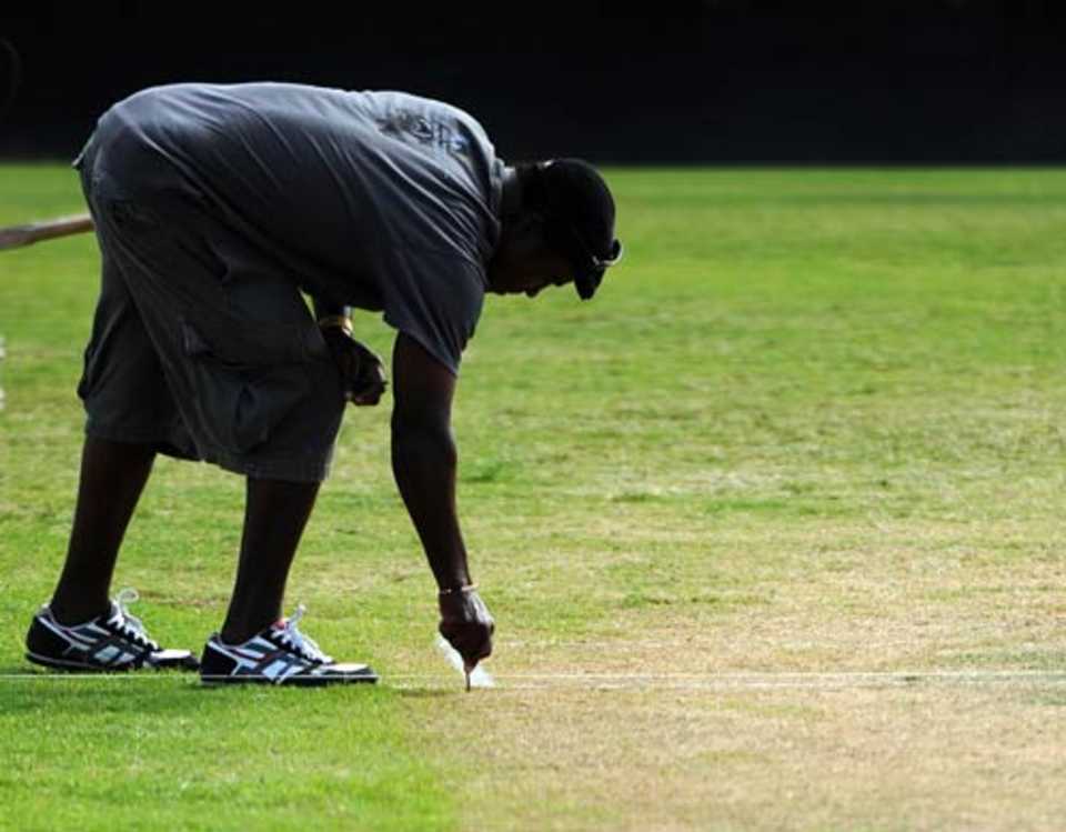A groundsman marks the pitch as the Antigua Recreation Ground readies to host the third Test