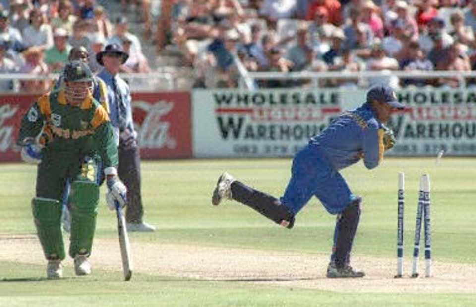 South African batsman Nicky Boje makes it home safely as Sri Lankan wicket-keeper Romesh Kaluwitharana attempts a run-out in the fourth one day international played at Newlands, Cape Town 11 January 2001.