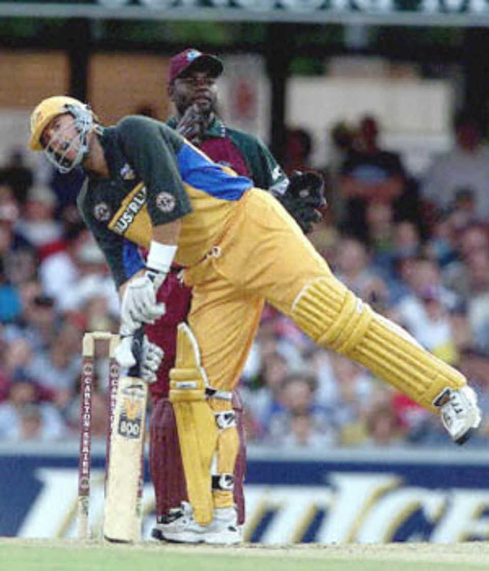 Mark Waugh loses his balance after playing a shot as Jacobs looks on, Carlton Series, 2000/01, 3rd Match, Australia v West Indies, Brisbane Cricket Ground, Woolloongabba, Brisbane, 14 January 2001.