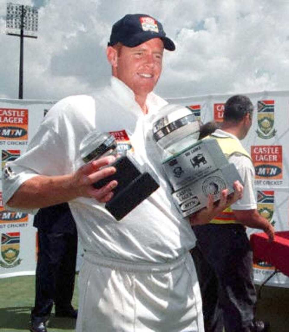 South African captain Shaun Pollock carries 22 January 2001 his trophies of 'Man of the Match' and 'Man of the Series' at close of play of the third and final five-day international played against the visiting Sri Lankans at Centurion Park, Pretoria.