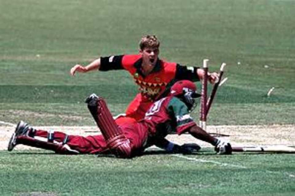 25 Jan 2001: Bryan Strang of Zimbabwe runs out Daren Ganga of the West Indies for six during the Carlton Series One Day International between West Indies and Zimbabwe at the Adelaide Oval in Adelaide, Australia.