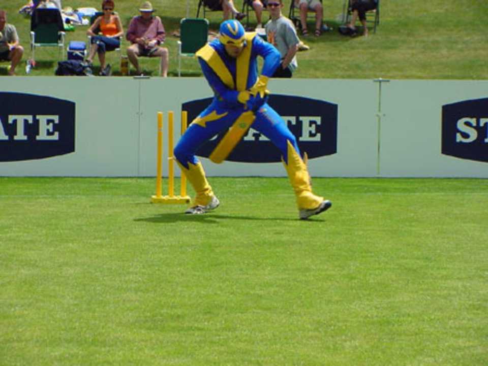 Voltman, Otago Cricket's live mascot, playing an extravagant shot in a pre-match promotion at the first match to be played at the new ground. State Shield: Otago v Wellington at John Davies Oval, Queenstown, 2 January 2002.