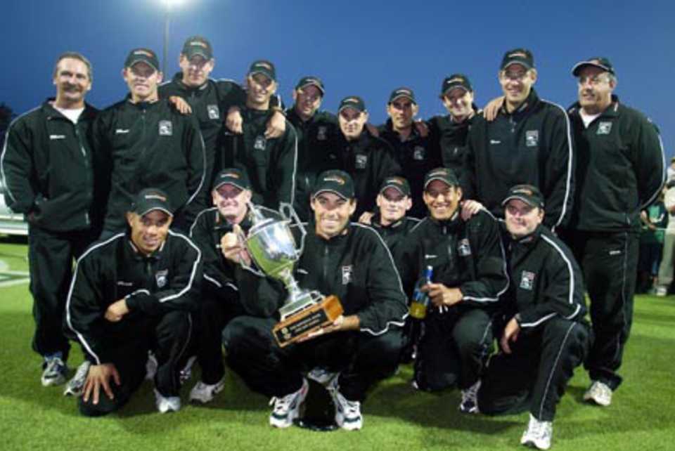 Members of the New Zealand team with the National Bank One-Day International Series trophy. Back (from left): player co-ordinator Ashley Ross, Lou Vincent, Jacob Oram, Shane Bond, Chris Harris, Brendon McCullum, Mathew Sinclair, Chris Cairns, Daniel Vettori and coach Denis Aberhart. Front: Andre Adams, Scott Styris, captain Stephen Fleming, Kyle Mills, Daryl Tuffey and Paul Hitchcock. 7th ODI: New Zealand v India at Westpac Park, Hamilton, 14 January 2003.