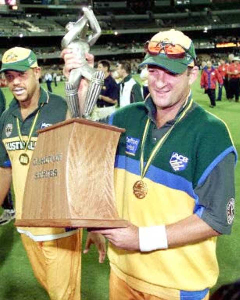 Australian batsman Mark Waugh carries the trophy after Australia won the 2nd one-day final against the West Indies to take out the series 2-0 at the MCG in Melbourne 09 February 2001. Australia amassed the huge total of 338-6 with Mark Waugh topscoring with 173 and in reply the West Indies scored 299 to lose by 39 runs. Waugh faces a meeting tomorrow 10 February with the ICC anti-corruption unit looking into allegations that Waugh was taking bribes from an Indian book-maker.