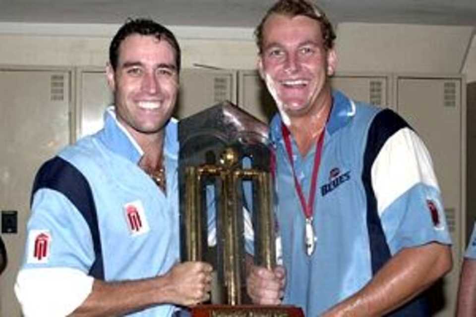25 Feb 2001: Michael Bevan #5 and Shane Lee#6 for the NSW Blues celebrate with the Mercantile Mutual Trophy, after the Mercantile Mutual Cup One Day final, between the Western Warriors and the NSW Blues, played at the WACA, Perth, Australia. The NSW Blues defeated the Western Warriors by 6 wickets.