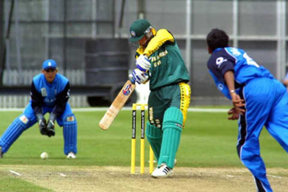 South Africa Under-19 batsman David Jacobs drives through the covers during his innings of 40. Wicket-keeper Stephen Pope looks on. ICC Under-19 World Cup Super League Group 2: England Under-19s v South Africa Under-19s at Lincoln Green, Lincoln, 1 February 2002.