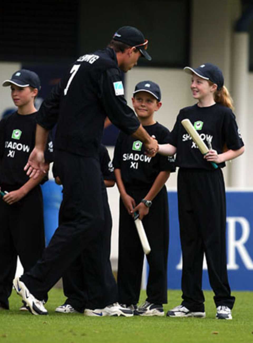 New Zealand captain Stephen Fleming shakes hands with members of the Shadow XI as his team walks on to the field. The Shadow XI receive a signed bat from a designated CLEAR Black Cap player before returning to free seats in the crowd. 3rd ODI: New Zealand v England at McLean Park, Napier, 20 February 2002.